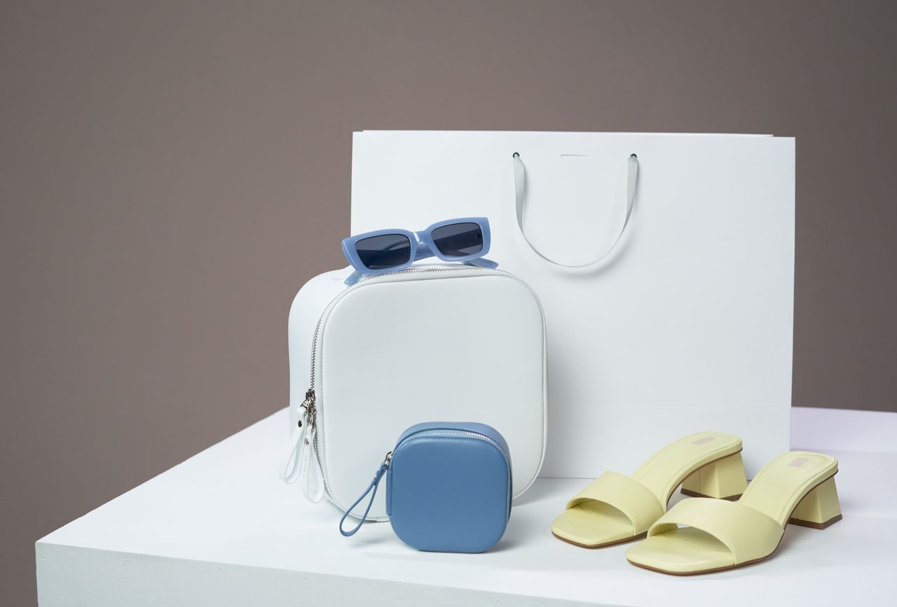 Mastering the First Impression: Your intriguing post title goes here Modern women's fashion accessories including bags, sandals, and sunglasses on a minimalist platform.